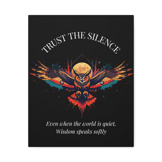 Close up of black canvas wall art print featuring colorful abstract owl with intense eyes, detailed feathers, geometric accents, and cosmic splatters on dark background. Arched white text "TRUST THE SILENCE" above and quote "Even when the world is quiet, wisdom speaks softly" below.