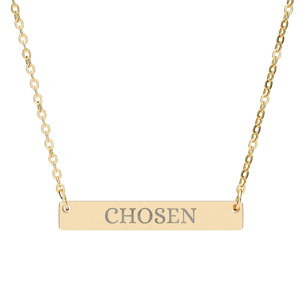 Gold bar necklace featuring engraved uppercase text "CHOSEN" on a sleek matte gold pendant, suspended on a delicate matching gold chain. Minimalist motivational affirmation jewelry for empowerment and self-worth.