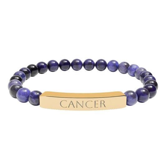 Bracelet with polished lapis lazuli and black onyx beads in deep blue and black tones, featuring a gold-plated curved bar engraved "CANCER" in uppercase letters. Stretch-fit zodiac-inspired crystal jewelry.