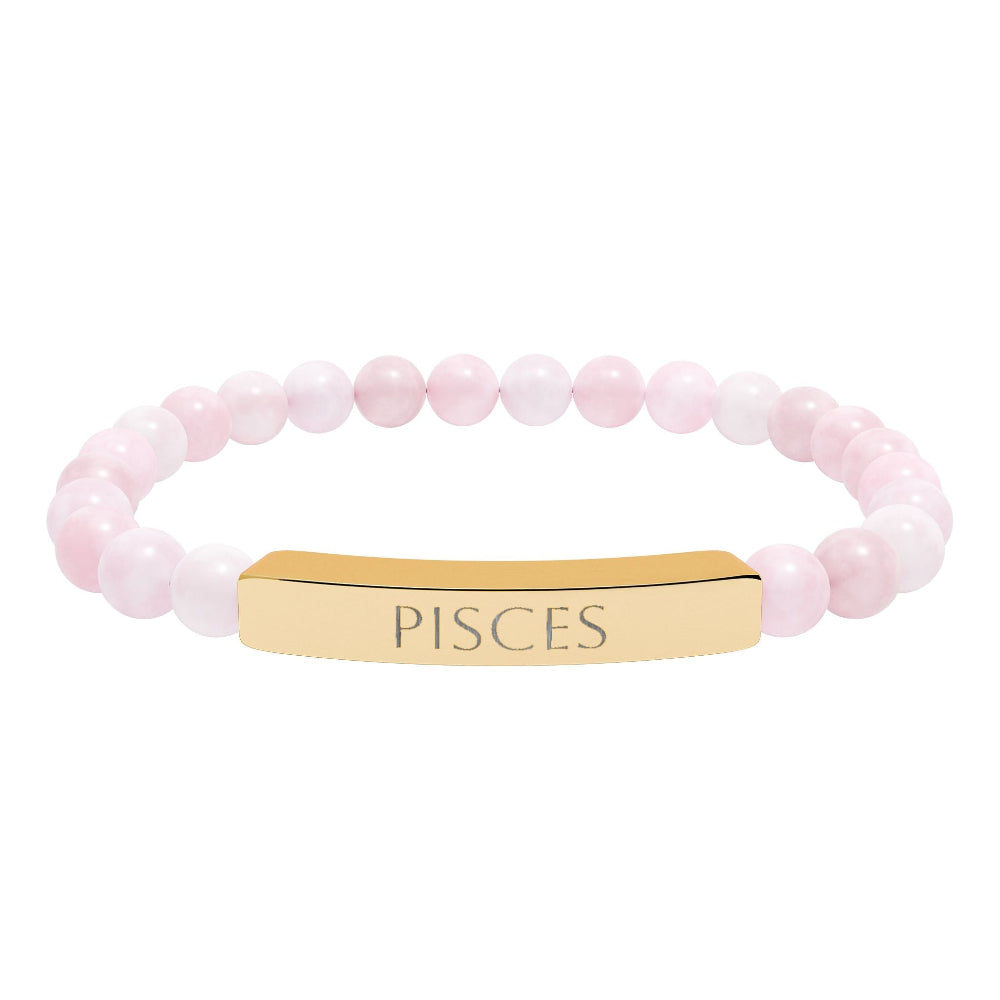 Bracelet with polished rose quartz beads in soft pink tones, natural translucent glow, paired with a gold-plated curved bar engraved "PISCES" in uppercase letters. Stretch-fit zodiac-inspired crystal jewelry.