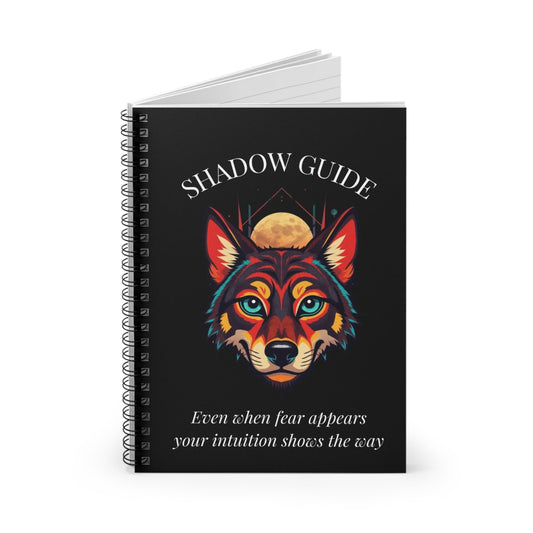 Notebook with a colorful abstract wolf head portrait, intense turquoise eyes, geometric accents, and paint splatters on a black background, featuring the words "SHADOW GUIDE" and quote "Even when fear appears, your intuition shows the way".