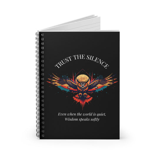 Notebook with a colorful abstract owl with intense eyes, moon accents, geometric details, and paint splatters on a black background, featuring the words "TRUST THE SILENCE" and quote "Even when the world is quiet, wisdom speaks softly".