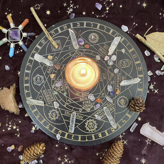 Lit candle placed in the center of a black and gold Wheel of the Year divination board, surrounded by clear quartz points, tumbled crystals, pinecones, and a crystal wand on a dark starry cloth. Mystical pagan altar setup for seasonal rituals and spiritual practice.