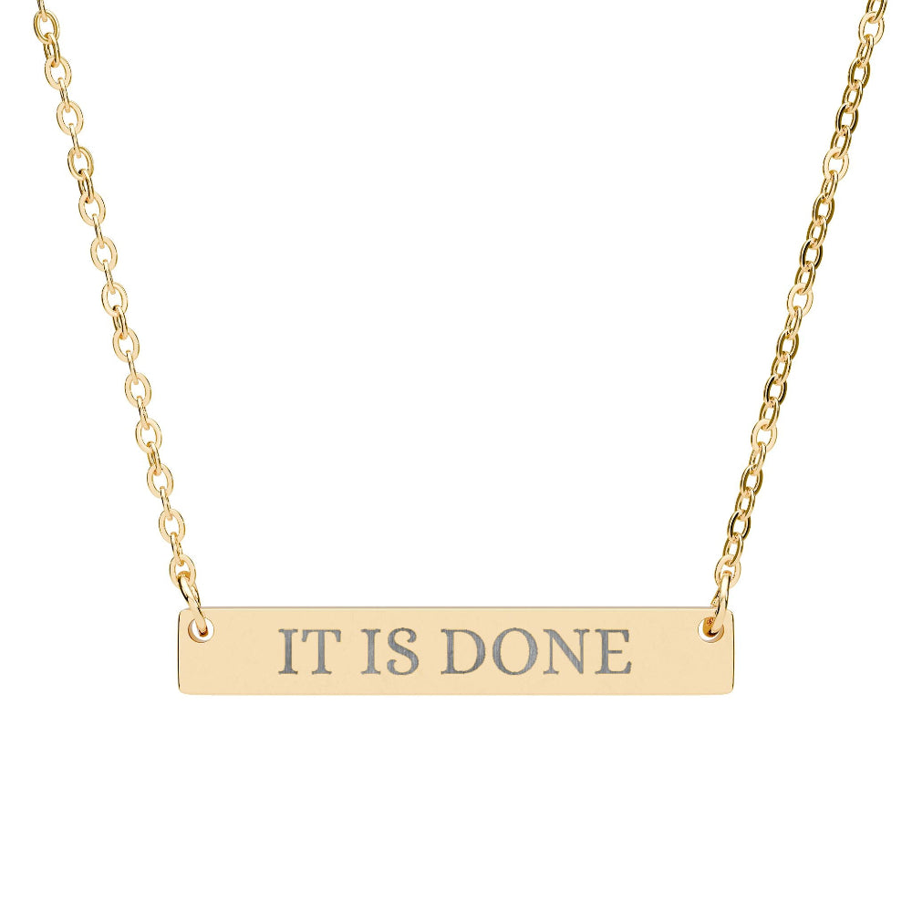 Gold bar necklace with engraved uppercase text "IT IS DONE" on a sleek matte pendant, suspended on a delicate matching gold chain. Minimalist motivational affirmation jewelry for manifestation and completion.