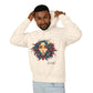 Young man with short hair pulling up the hood of a cream hoodie featuring vibrant artistic portrait of a fierce woman with curly multicolored flowing hair, teal red blue face accents, large hoop earrings, third-eye symbol, "Feral" text below