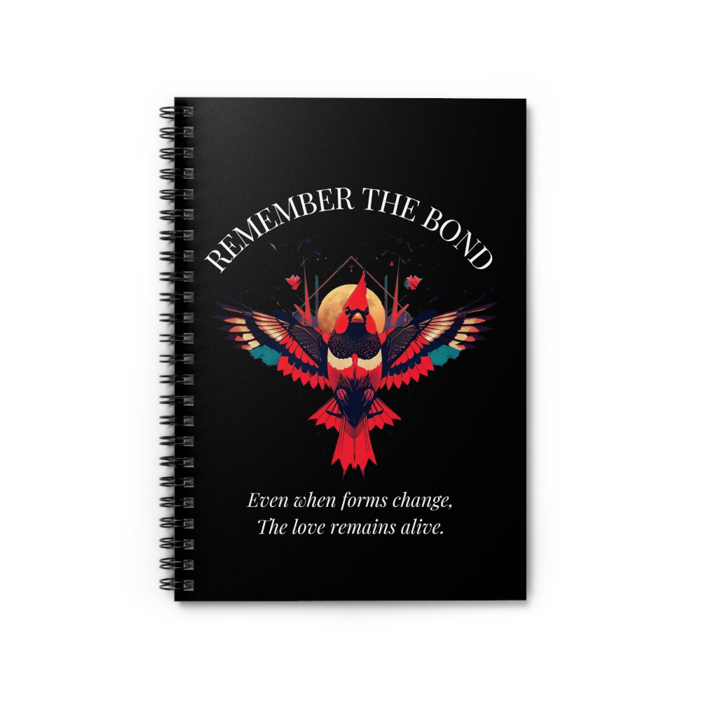 Spiral notebook with 'Remember The Bond' motivational cover design featuring a colorful bird illustration and quote 'Even when forms change, The love remains alive' on a black background.