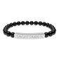 Bracelet with polished black onyx beads and silver curved bar engraved "SAGITTARIUS" in uppercase letters. Stretch-fit zodiac-inspired crystal jewelry.