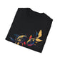 Black folded unisex cotton t-shirt featuring bold Pisces zodiac graphic print: vibrant abstract twin goldfish swimming in mirrored formation, detailed scales and flowing fins, intense eyes, geometric accents, and dynamic multicolored paint splatters in gold, red, navy, teal, blue, and black tones bursting outward. Elegant white cursive "Pisces" text below. Astrology zodiac motivational crewneck tee.
