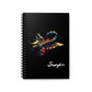 Notebook with a colorful abstract Scorpio scorpion illustration, raised stinger, intricate tail and pincers, geometric patterns, and paint splatters on a black background, featuring the word "Scorpio".