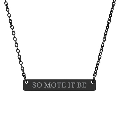 Black bar necklace featuring engraved silver text "SO MOTE IT BE" on a matte black pendant, suspended on a delicate black chain. Minimalist occult-inspired jewelry with Wiccan/Pagan affirmation for manifestation and intention setting.