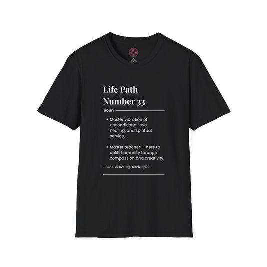Black unisex cotton t-shirt laid out flat featuring bold Life Path Number 33 numerology print in dictionary style: exact text reading "Life Path Number 33 noun · Master vibration of unconditional love, healing, and spiritual service. · Master teacher — here to uplift humanity through compassion, kindness, and creativity. – see also: healing, teach, uplift". Motivational spiritual numerology crewneck tee flat lay with visible purple/gold zodiac wheel inner tag.