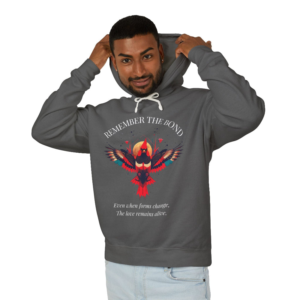 Man modeling a charcoal grey hoodie with 'Remember The Bond' inspirational bird graphic and quote 'Even when forms change, The love remains alive' printed on the front.
