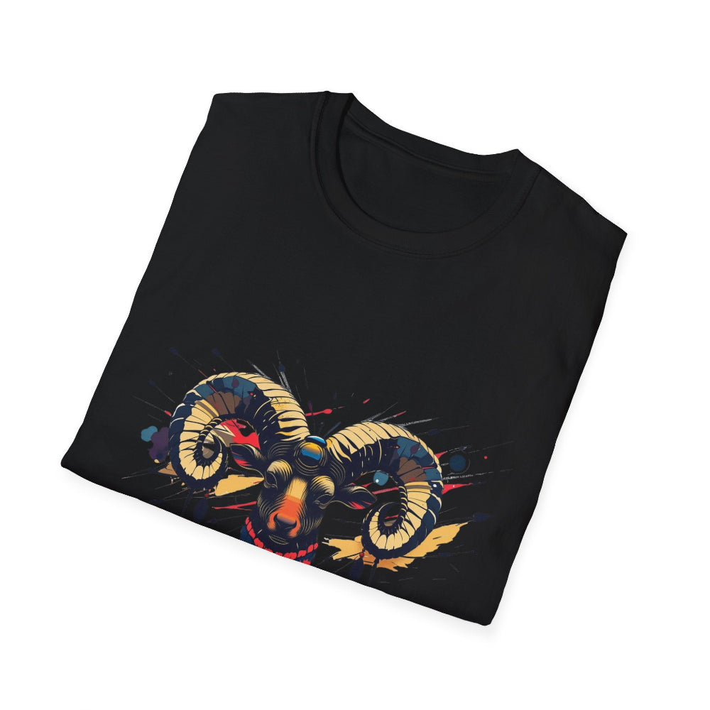 Black folded unisex cotton t-shirt featuring bold Aries zodiac graphic print: vibrant abstract ram head portrait with large curved horns, intense expression, geometric patterns, and dynamic multicolored paint splatters in gold, red, navy, teal, and black tones exploding outward. Elegant white cursive "Aries" text below. Astrology zodiac motivational crewneck tee.