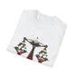White folded unisex cotton t-shirt featuring bold Libra zodiac graphic print: vibrant abstract scales of justice with balanced arms, intricate geometric triangular motifs, central axis design, symmetrical layout, and dynamic multicolored paint splatters in gold, red, navy, teal, and black tones bursting outward. Elegant black cursive "Libra" text below. Astrology zodiac motivational crewneck tee.