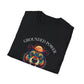 Black folded unisex cotton t-shirt featuring bold "Grounded Power" graphic: vibrant abstract bear head portrait with intense expression, colorful geometric accents, and dynamic paint splatters in red, orange, teal, blue, and gold tones bursting outward around an orange moon background. Arched white text "GROUNDED POWER" above and smaller inspirational quote "Even when life is overwhelming, your roots keep you steady" below. Motivational spiritual empowerment crewneck tee.