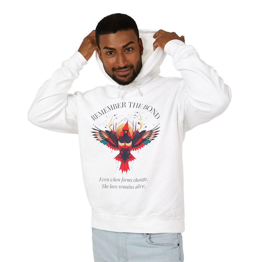 Man modeling a white hoodie with 'Remember The Bond' inspirational bird graphic and quote 'Even when forms change, The love remains alive' printed on the front.