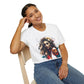 White plus-size unisex cotton t-shirt modeled by smiling woman with braided hair, hand on cheek, featuring bold "Feral" graphic on chest: vibrant abstract portrait of a fierce woman with wild flowing hair, intense expression, tribal markings, colorful geometric accents, and dynamic paint splatters in red, orange, teal, blue, and gold tones bursting outward around an orange moon background. White elegant cursive "Feral" text below. Wild feminine energy motivational crewneck tee.