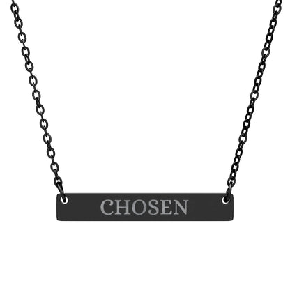 Black bar necklace with engraved uppercase text "CHOSEN" on a matte black pendant, suspended on a delicate black chain. Minimalist motivational jewelry for affirmation, empowerment, and self-worth.