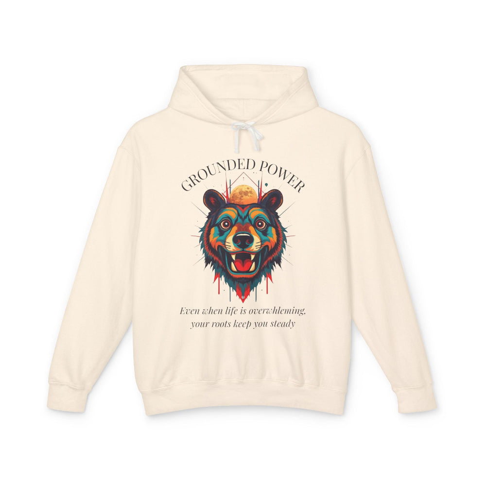 Cream hoodie with vibrant multicolored bear head graphic, roaring expression, fur in blue orange teal splashes, full moon above, "GROUNDED POWER" arched text, motivational quote "Even when life is overwhelming, your roots keep you steady" below