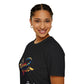 Black unisex cotton t-shirt in side profile on smiling woman with braided hair, featuring bold Scorpio zodiac graphic on chest: vibrant abstract scorpion silhouette with raised stinger, intense glowing eyes, detailed tail and pincers, geometric patterns, and explosive multicolored paint splatters in gold, red, navy, teal, and black tones bursting outward. Elegant white cursive "Scorpio" text below. Astrology zodiac motivational crewneck tee.
