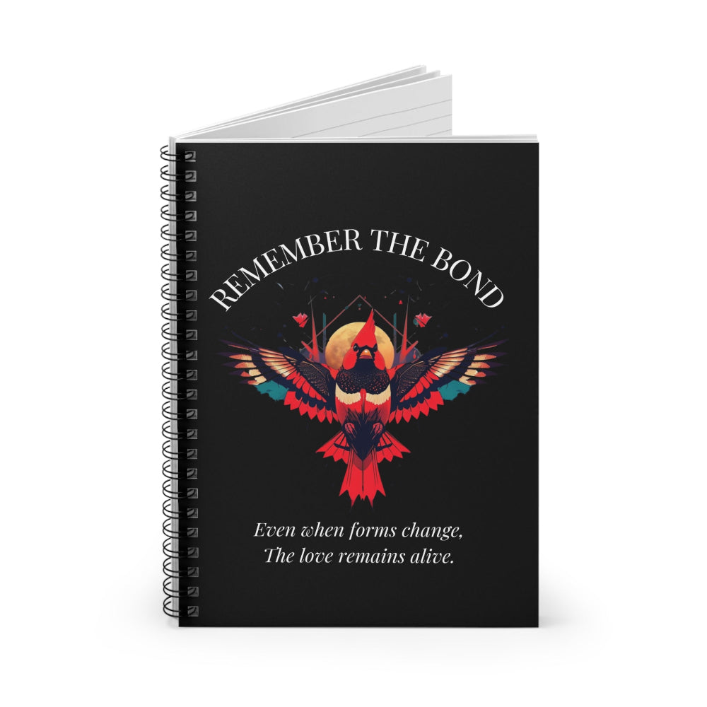 Spiral notebook with 'Remember The Bond' motivational cover design featuring a colorful bird illustration and quote 'Even when forms change, The love remains alive' on a black background.
