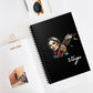 Notebook with a colorful abstract Virgo woman holding wheat sheaf, serene expression, stylish hair, and paint splatters on a black cover, featuring the word "Virgo" in elegant white cursive, placed on a clean desk with sunglasses and stationery items.