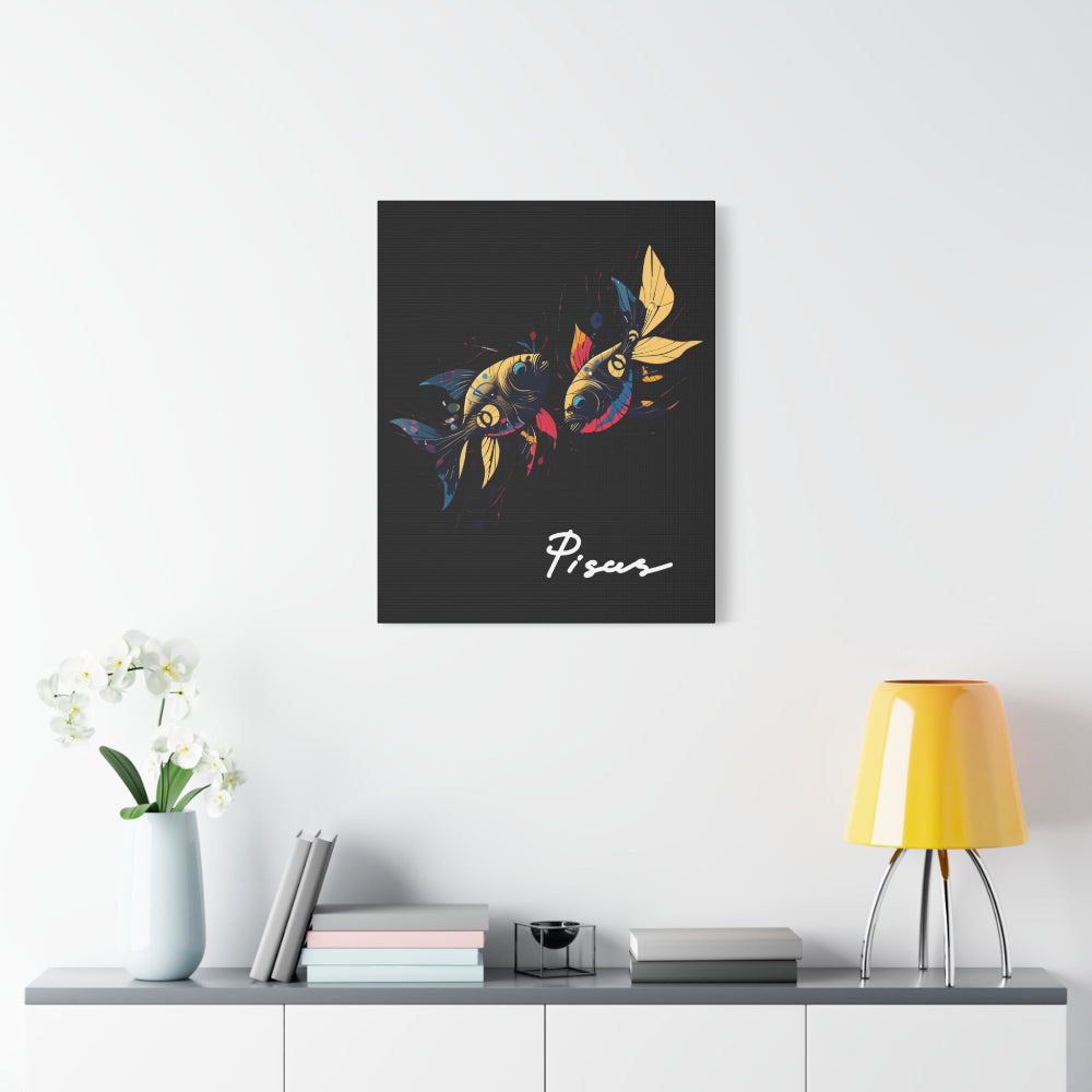 Black canvas wall art print of colorful abstract mirrored fish with flowing fins and cosmic splatters on dark background, featuring "Pisces" in elegant white cursive displayed in a modern home décor setting above a console table with books and yellow lamp.