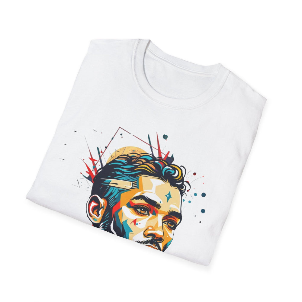 White folded unisex cotton t-shirt featuring bold Primal graphic print: stylized intense bearded man portrait with stylish hair, vibrant multicolored geometric face in teal, orange, red, and yellow tones, dynamic paint splatters and abstract shards exploding outward. Elegant black cursive "Primal" text below. Primal masculine energy motivational crewneck tee.