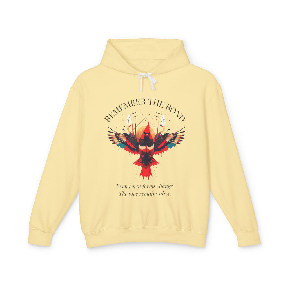 Yellow hoodie with 'Remember The Bond' inspirational bird graphic and quote 'Even when forms change, The love remains alive' printed on the chest.