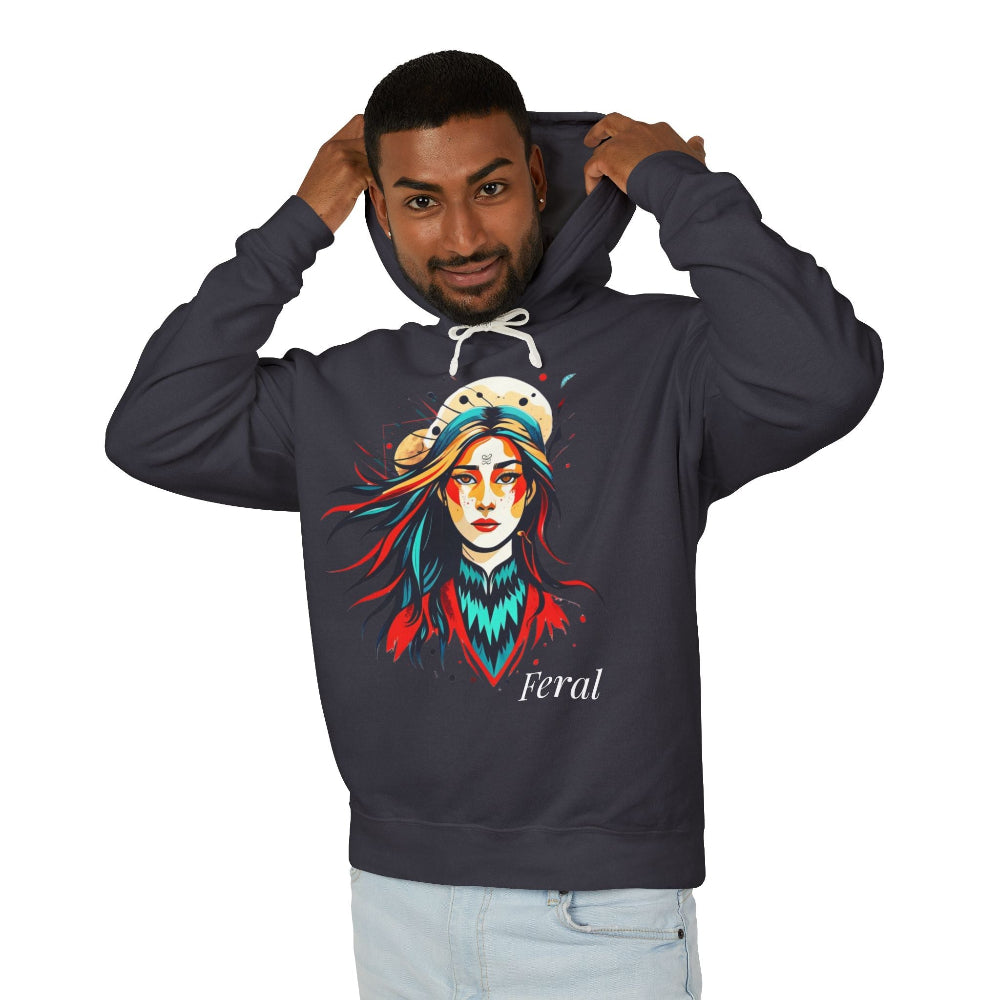 Young man with short hair pulling up the hood of a black hoodie featuring vibrant artistic print of a fierce woman with long flowing hair, red-orange armored top, colorful paint splash design, "Feral" text below