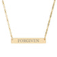 Gold bar necklace with engraved uppercase text "FORGIVEN" on a sleek matte pendant, suspended on a delicate matching gold chain. Minimalist motivational affirmation jewelry for forgiveness, healing, and emotional release.
