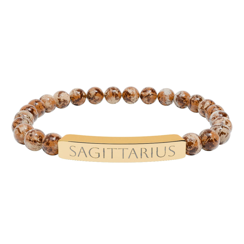 Bracelet with polished leopard jasper beads in earthy brown tones with natural veining, featuring a gold-plated curved bar engraved "SAGITTARIUS" in uppercase letters. Stretch-fit zodiac-inspired crystal jewelry.