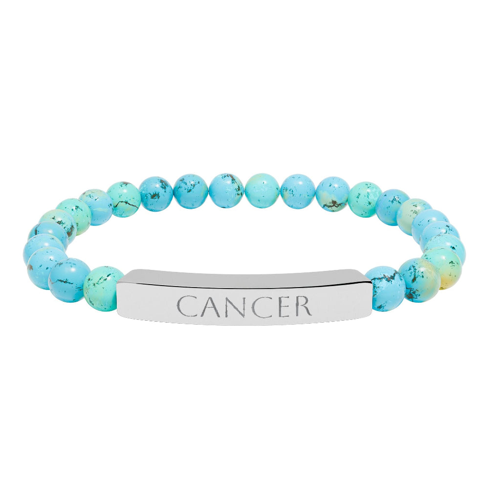 Bracelet with polished turquoise beads in soft aqua-blue tones with natural veining and speckles, featuring a silver curved bar engraved "CANCER" in uppercase letters. Stretch-fit zodiac-inspired crystal jewelry.