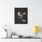 Black canvas wall art print of colorful abstract Virgo woman holding wheat sheaf, serene expression, stylish hair, and cosmic splatters on dark background, featuring "Virgo" in elegant white cursive displayed in a modern home décor setting above a console table with books and yellow lamp.