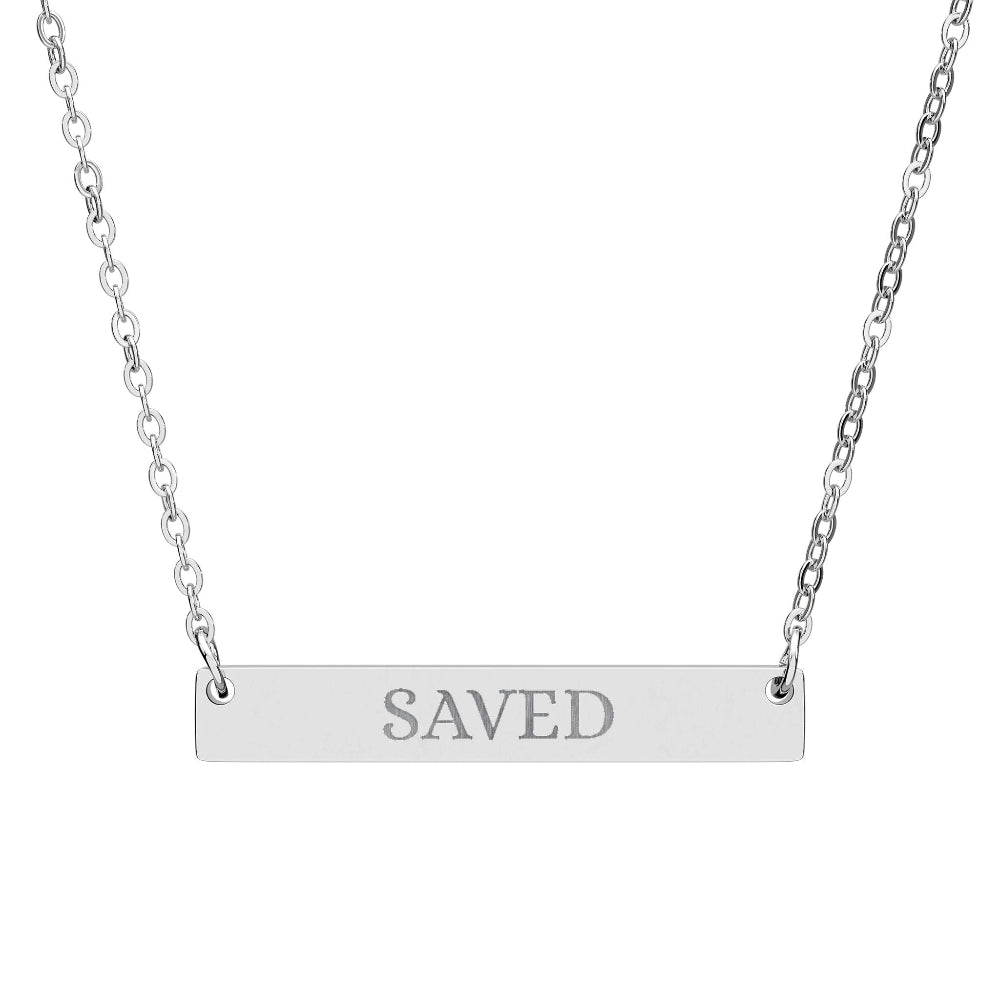 Silver bar necklace with engraved uppercase text "SAVED" on a sleek matte silver pendant, suspended on a delicate matching silver chain. Minimalist motivational affirmation jewelry for grace, redemption, and spiritual protection.