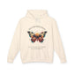 Cream hoodie featuring a colorful abstract butterfly graphic with the word "TRANSFORMATION" arched above and the quote "Even when process feels fragile, you are becoming free