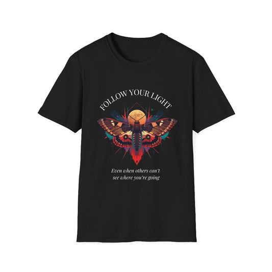 Black unisex cotton t-shirt featuring bold "Follow Your Light" graphic: vibrant abstract moth with detailed wings, intense expression, colorful geometric accents, and dynamic paint splatters in red, orange, teal, blue, and gold tones bursting outward around an orange moon background. Arched white text "FOLLOW YOUR LIGHT" above and smaller inspirational quote "Even when others can't see where you're going, see with your own eyes" below. Motivational spiritual empowerment crewneck tee.