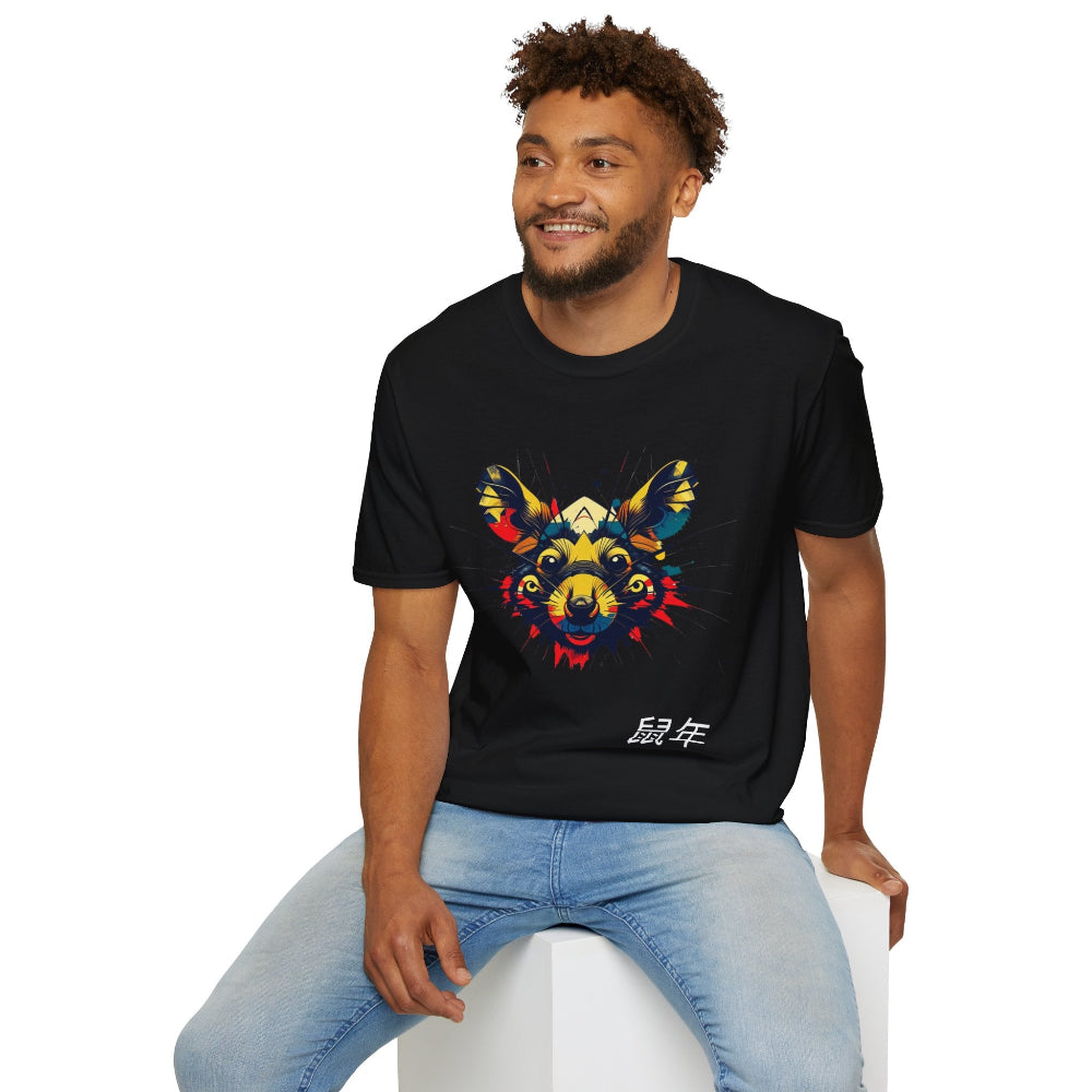 Black unisex cotton t-shirt modeled by smiling man with curly hair and beard, featuring bold Year of the Rat graphic: vibrant abstract rat face portrait with large ears, intense eyes, geometric patterns, and multicolored paint splatters in yellow, red, blue, teal, and orange. Chinese text "鼠年" (Year of the Rat) printed below in white. Zodiac Chinese New Year motivational crewneck tee.