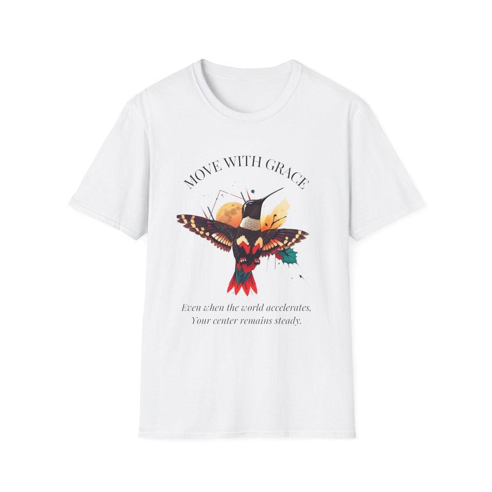 White t-shirt featuring a vibrant hummingbird graphic with the text "MOVE WITH GRACE" arched above and the quote "Even when the world accelerates, Your center remains steady" below. Motivational spiritual apparel.