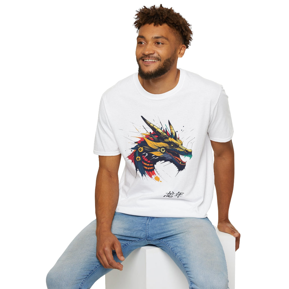 White unisex cotton t-shirt modeled by smiling man with curly hair and beard, featuring bold Year of the Dragon graphic: vibrant abstract dragon head portrait with fierce open mouth, sharp golden horns, intricate scales, flowing mane, and dynamic multicolored paint splatters in gold, red, black, blue, teal, and orange tones exploding outward. Chinese text "龙年" (Year of the Dragon) printed below in black. Zodiac Chinese New Year motivational crewneck tee.
