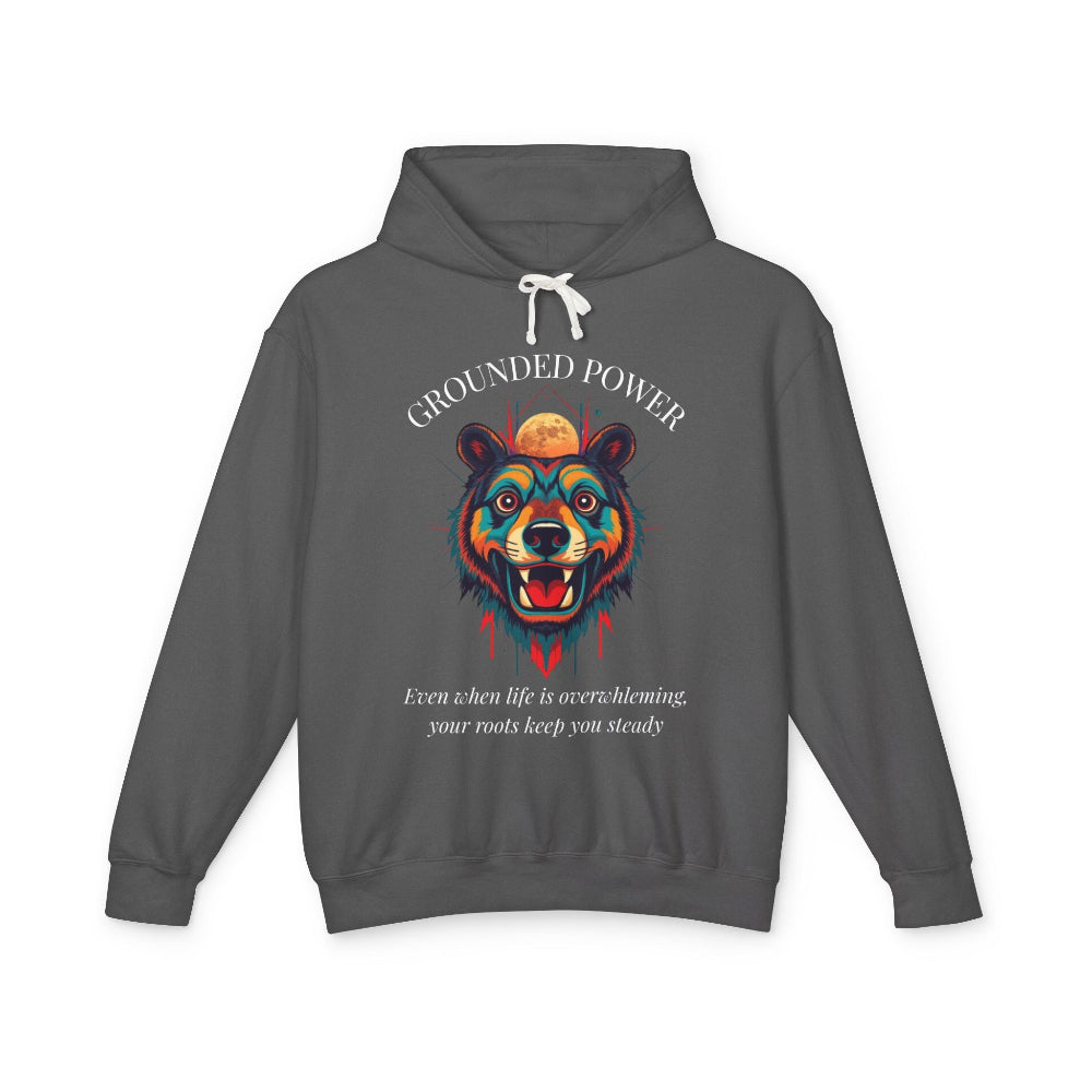 Dark gray hoodie with vibrant multicolored bear head graphic, roaring expression, mane in blue orange teal splashes, full moon above, "GROUNDED POWER" arched text, motivational quote "Even when life is overwhelming, your roots keep you steady" below