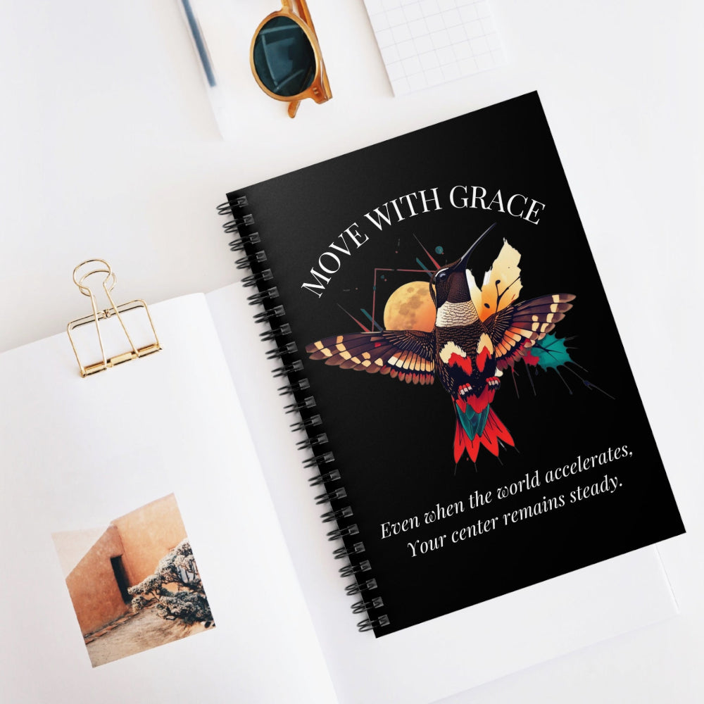 Lifestyle shot of the "Move With Grace" hummingbird notebook on a bright, modern desk. Perfect for a workspace or morning journaling routine.