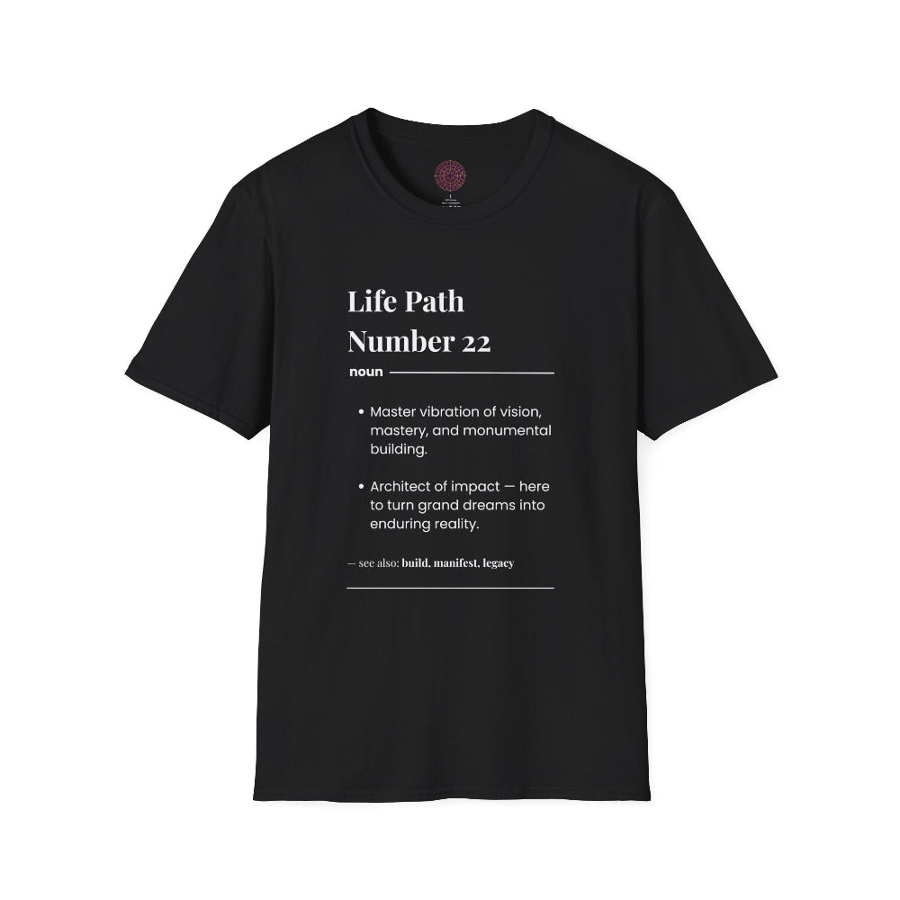 Black unisex cotton t-shirt laid out flat featuring bold Life Path Number 22 numerology print in dictionary style: exact text reading "Life Path Number 22 noun · Master vibration of vision, mastery, and monumental building. · Architect of impact — here to turn grand dreams into enduring reality. – see also: build, manifest, legacy". Motivational spiritual numerology crewneck tee flat lay with visible purple/gold zodiac wheel inner tag.