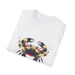 White folded unisex cotton t-shirt featuring bold Cancer zodiac graphic print: vibrant abstract crab portrait with large claws, intense eyes, symmetrical geometric shell patterns, and dynamic multicolored paint splatters in gold, red, navy, teal, and black tones exploding outward. Elegant black cursive "Cancer" text below. Astrology zodiac motivational crewneck tee.