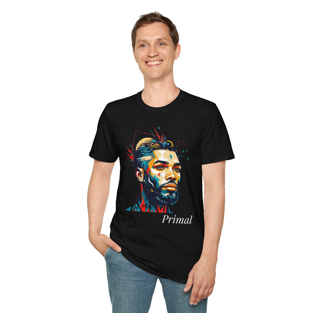 Black unisex cotton t-shirt modeled by smiling man with hand in pocket, featuring bold "Primal" graphic: stylized intense bearded man portrait with short styled hair, vibrant multicolored geometric face in red, teal, orange, blue and yellow tones, dynamic paint splatters bursting outward. Elegant white cursive "Primal" text below. Primal masculine energy motivational crewneck tee.