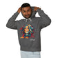 Young man with short hair pulling up the hood of a dark gray hoodie featuring vibrant artistic portrait of a fierce woman with curly multicolored flowing hair, teal red blue face accents, bold makeup, "Feral" text below