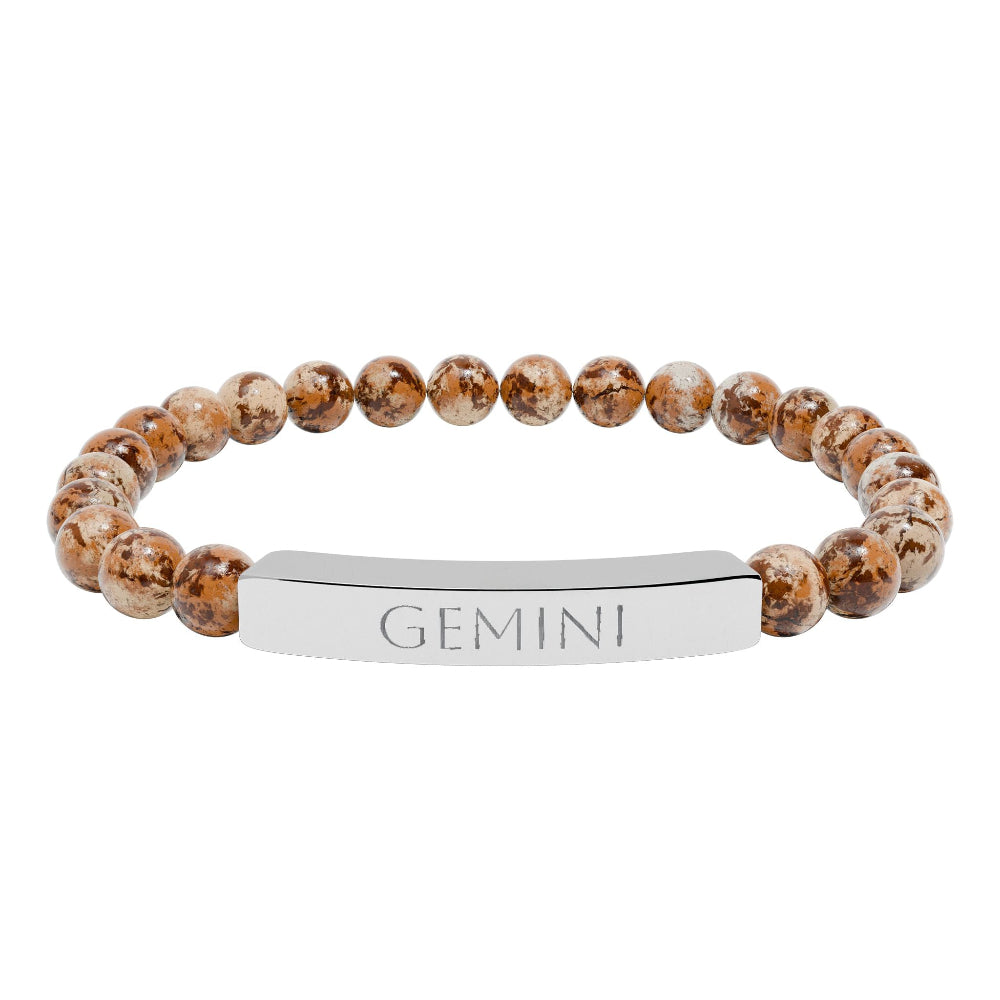 Bracelet with polished leopard jasper beads in earthy brown tones with natural veining, featuring a silver curved bar engraved "GEMINI" in uppercase letters. Stretch-fit zodiac-inspired crystal jewelry.