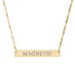 Gold bar necklace featuring engraved uppercase text "MAGNETIC" on a sleek matte gold pendant, suspended on a delicate matching gold chain. Minimalist motivational affirmation jewelry for attraction, charisma, and positive energy.