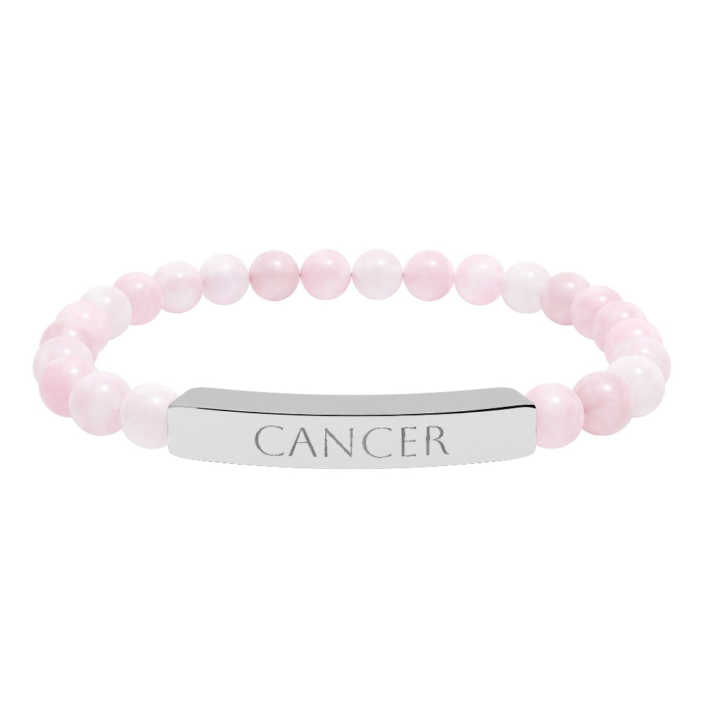 Bracelet with polished rose quartz beads in soft pink tones and natural translucent glow, paired with a silver curved bar engraved "CANCER" in uppercase letters. Stretch-fit zodiac-inspired crystal jewelry for emotional depth, nurturing, and intuition.