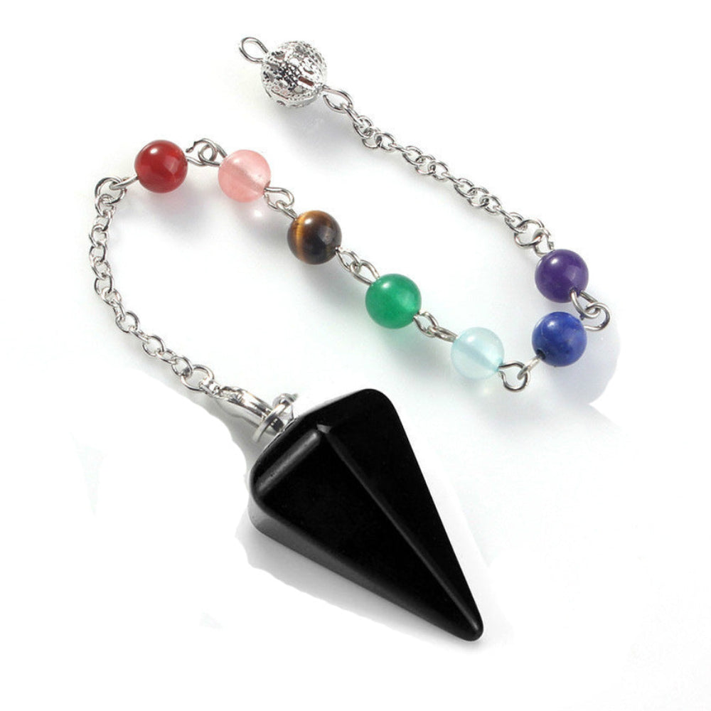 Silver pendulum with a large polished black onyx triangular point, attached to a chain with seven chakra gemstone beads (red jasper, rose quartz, tiger's eye, green aventurine, aquamarine, lapis lazuli, amethyst) and an ornate silver acorn charm. Chakra dowsing tool for divination and energy healing.